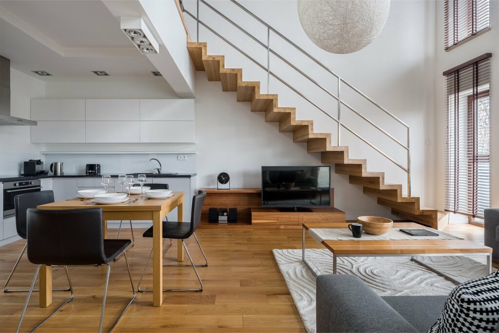Contemporary home interior with natural hardwood flooring and modern floating staircase design