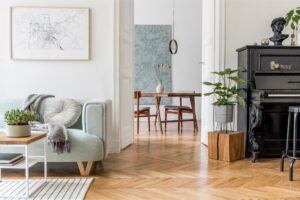 Herringbone hardwood flooring with area rug accents in a bright and elegant home interior