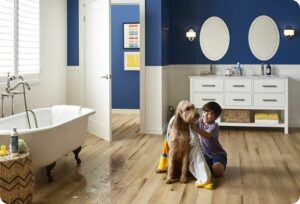Pet friendly wood look flooring in family bathroom with child and dog showing durable flooring for active households